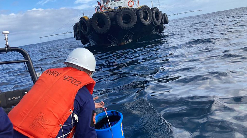 Philippine Coast Guard collect water samples from an oil spill from Princess Empress