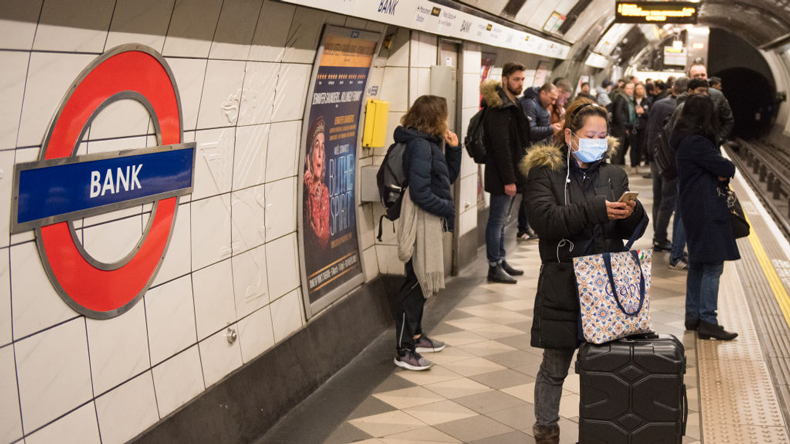 Woman in anti-coronavirus mask on London Tube. John Keeble / Getty Images