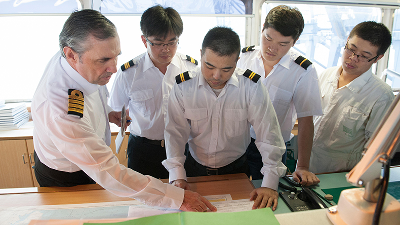 Captain and officers discuss navigation plans