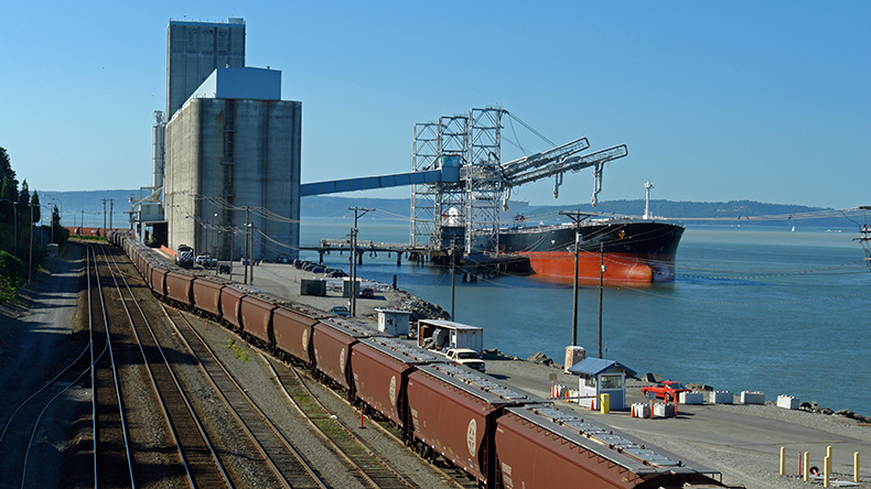 Grain elevator with dry bulker and railroad tracks at Tacoma Washington, USA