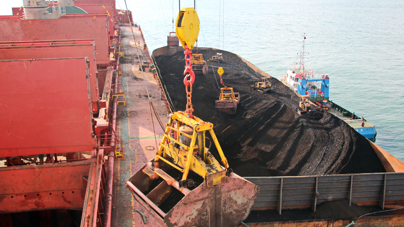 Loading coal from a barge at Samarinda, Indonesia. Credit Ivan Kuzkin/Shutterstock.com
