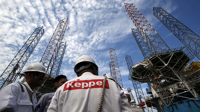 Keppel FELS employees stand among jackup rigs in Singapore in 2016