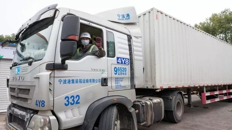 Truck driver with facemask at Ningbo port