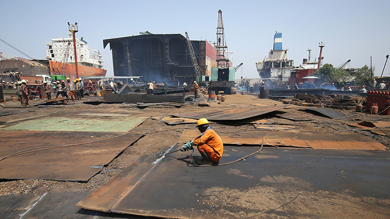 Workers dismantle a decommissioned ship at Alang, India in 2018