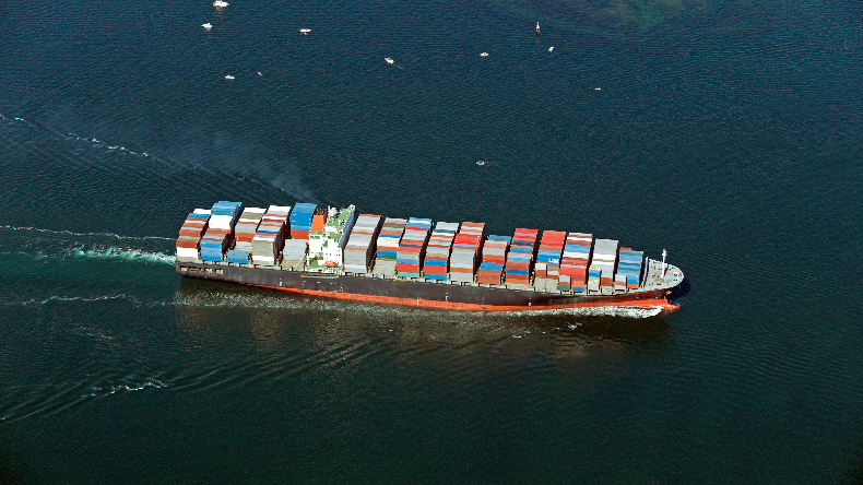 Loaded containership seen from above on a dark sea
