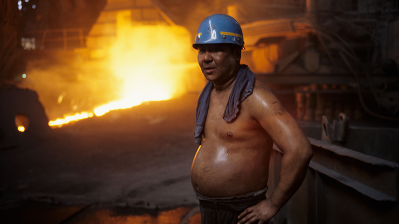 A steel worker in front of a blast furnace in Benxi Iron and Steel Group in Liaoning, China. 01 Sep 2005