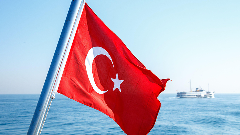 Turkish flag flying on the back of a boat at sea