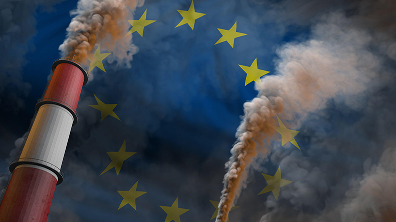 European Union flag behind heavy smoke