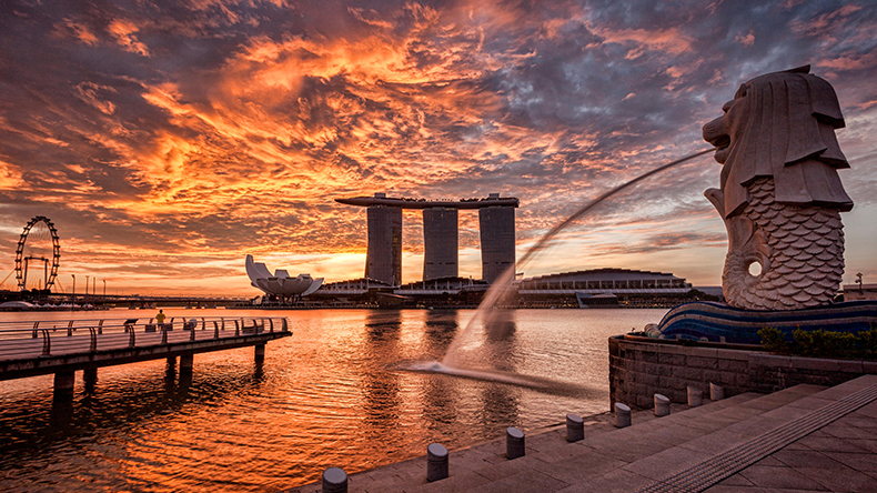 Singapore skyline at sunrise, with the Merlion and the Marina Bay Sands