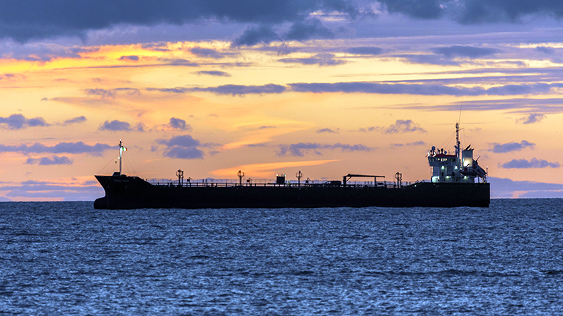 Oil tanker at anchor as dawn light breaks