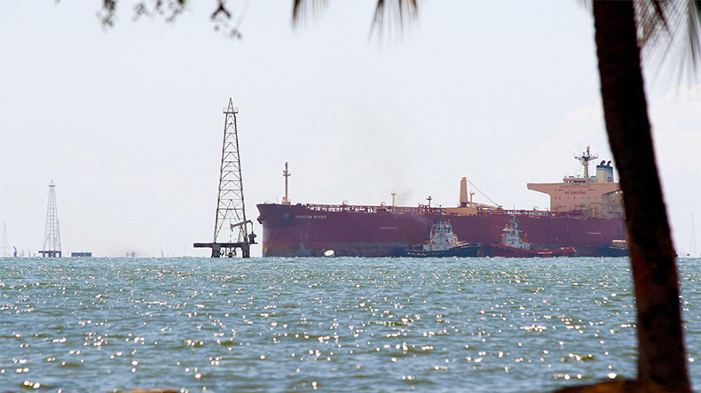 An oil tanker is towed to Pdvsa port in Salina