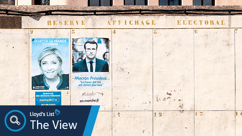 Image of posters of Marine Le Pen and Emmanuel Macron on a wall