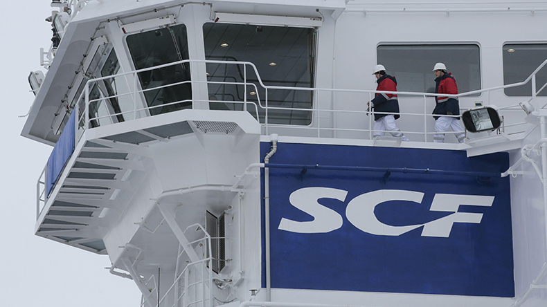 Sovcomflot logo on tanker with seafarers. Image ID: 2CH96M8